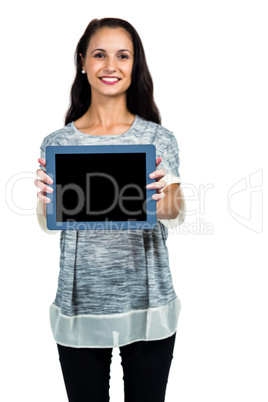 Smiling woman showing tablet screen at camera