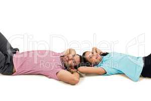 Smiling couple laying on floor with hands on their heads