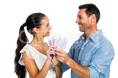 Smiling couple holding money