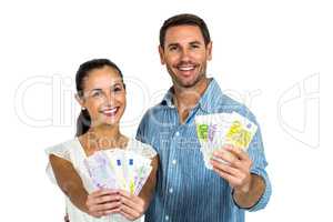 Confident couple holding money