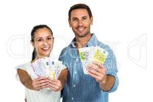 Portrait of couple holding money