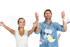 Happy couple throwing money