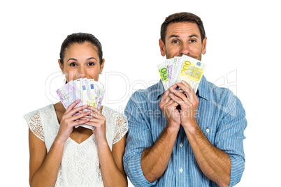 Excited couple holding money