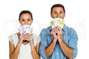 Excited couple holding money