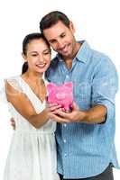 Young couple holding piggybank