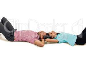 Peaceful young couple laying on floor with hands on their heads