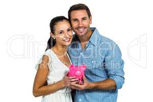 Couple holding pink piggybank