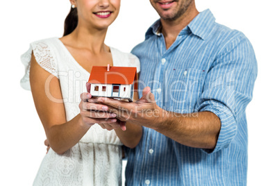 Couple holding house model