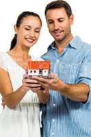 Young couple holding house model