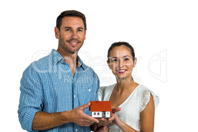 Man and woman holding house model