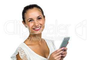 Smiling woman holding smartphone and looking at camera