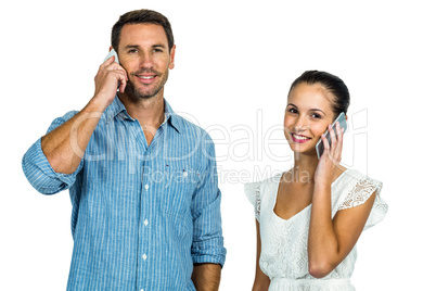 Smiling couple on phone call looking at the camera