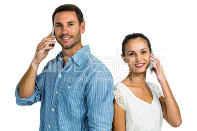 Portrait of couple on phone call looking at the camera