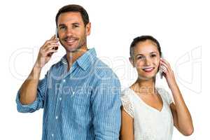 Portrait of couple on phone call looking at the camera