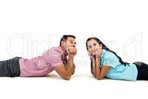 Young couple laying on floor looking away