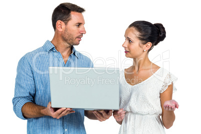 Worried couple using laptop