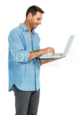 Smiling man using laptop