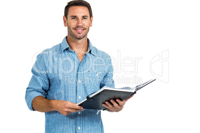 Smiling man holding book