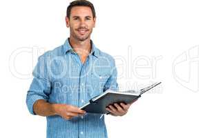 Smiling man holding book