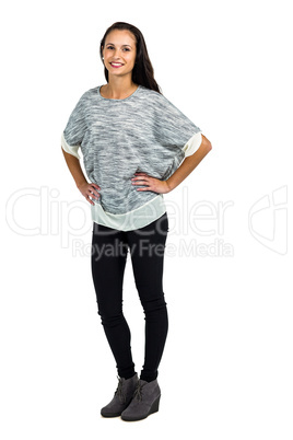 Smiling woman with hands on hips posing for camera