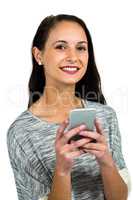 Smiling woman using smartphone and looking at the camera