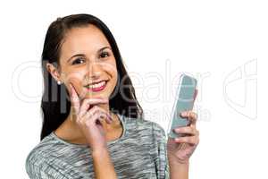 Smiling woman with hand on cheek using smartphone