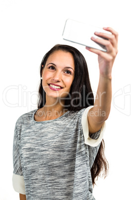 Smiling young woman taking selfie