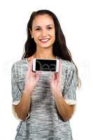 Smiling woman showing smartphone screen at camera