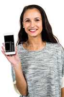 Smiling woman showing smartphone screen at camera