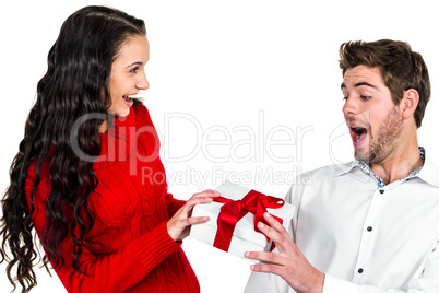 Smiling woman giving gift to her surprised boyfriend