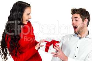 Smiling woman giving gift to her surprised boyfriend
