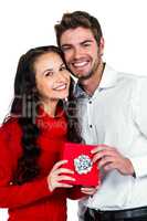 Smiling couple holding gift box