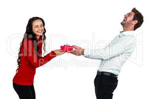 Happy young couple holding gift box