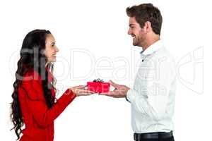 Excited young couple holding gift box