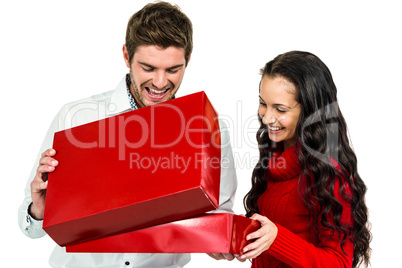 Smiling couple opening gift box