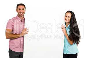 Confident smiling couple holding white sheet