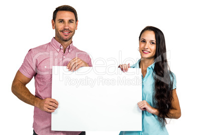 Smiling couple showing blank sheet