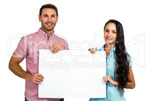 Smiling couple showing blank sheet