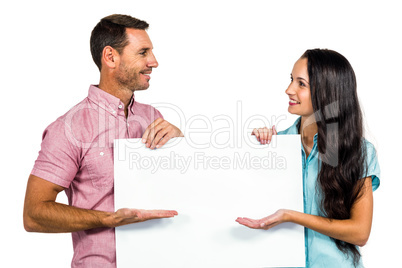 Young couple showing blank sheet