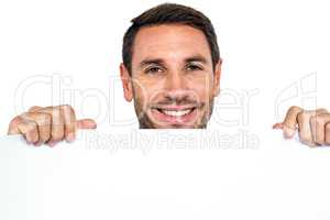 Smiling man holding blank sheet
