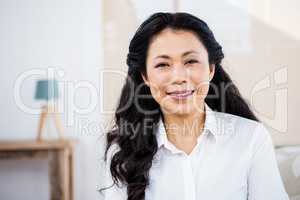 Smiling woman sitting at home