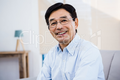 Happy man sitting at home