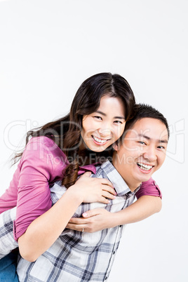 Man giving woman a piggyback