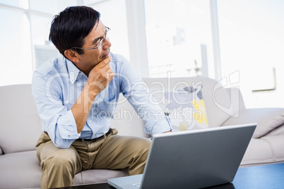 Smiling man at home on couch