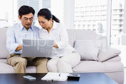 Smiling man at home on couch