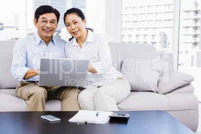 Smiling man at home on couch