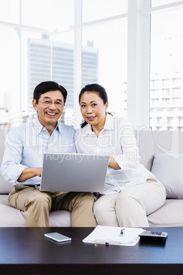 Smiling man at home on couch