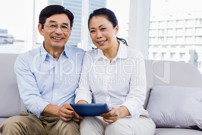 Smiling man at home on couch