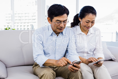 Man and woman sitting on couch