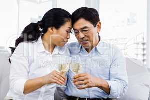 Mature man and woman with glasses of wine